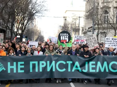 People carry a banner reading 'We don't agree' during a protest organised by ProGlas, the Serbian pro-democracy movement, amid opposition claims of major election law violations in the Belgrade city and parliament races, in Belgrade, Serbia, December 30, 2023. REUTERS/Zorana Jevtic