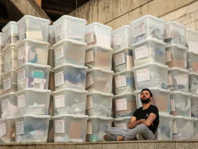 FILE PHOTO: An electoral worker sits next to boxes as Lebanese await the official election results for the rest of the districts in Lebanon's parliamentary election, at the Justice Palace in Jdeideh, Lebanon May 16, 2022. REUTERS/Mohamed Azakir/File Photo