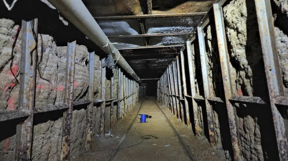 This undated photo provided by Homeland Security Investigations shows the inside of a cross border tunnel between Mexico's Tijuana into the San Diego area. Authorities announced on Monday, May 16, 2022, the discovery of the underground smuggling tunnel on Mexico's border, running the length of a football field on U.S. soil to a warehouse in an industrial area. The cross-border tunnel from Tijuana to the San Diego area was built in one of the most fortified stretches of the border, illustrating the limitations of former President Donald Trump's border wall. (Homeland Security Investigations via AP)