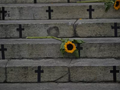 Sunflowers and crosses cover the City Council steps during a protest against femicide on International Women's Day in Rio de Janeiro, Brazil, Friday, March 8, 2024. (AP Photo/Silvia Izquierdo)