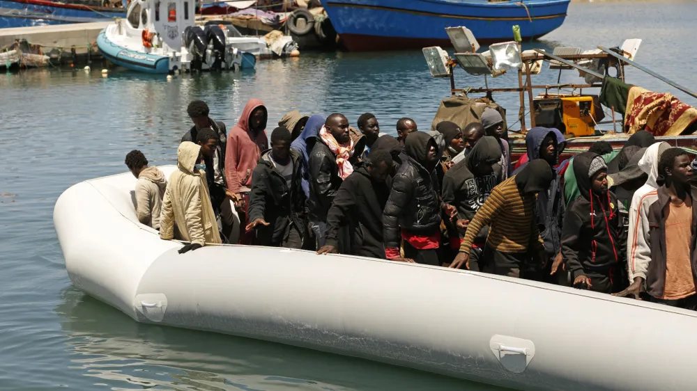 Migrants heading to Europe are brought back to port after being intercepted in the Mediterranean Sea by the Libyan coast guard, in Gasr Garabulli, northwestern Libya, Monday, May 23 2022. (AP Photo/Yousef Murad)