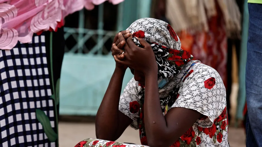 Kaba, a mother of a ten-day-old baby, reacts as she sits outside the hospital, where newborn babies died in a fire at the neonatal section of a regional hospital in Tivaouane, Senegal, May 26, 2022. REUTERS/Zohra Bensemra