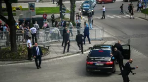 FILE PHOTO: Security officers move Slovakia's Prime Minister Robert Fico into a car after he was shot at close range in an assassination attempt, after a government meeting in Handlova, Slovakia, May 15, 2024. REUTERS/Radovan Stoklasa   TPX IMAGES OF THE DAY/File Photo