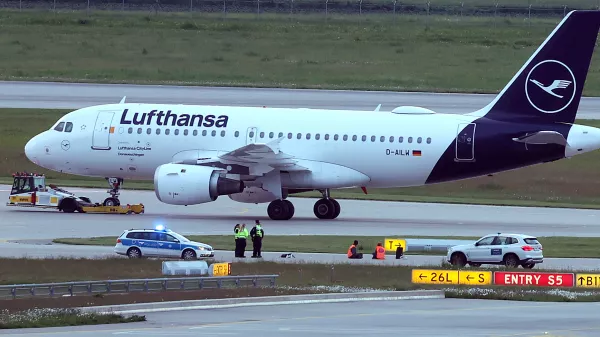 18 May 2024, Bavaria, Munich: Two activists have glued themselves to an access road for runways at Franz-Josef-Strauß Airport. The activists had reached the inner area of the airport grounds. According to their own statements, members of the 'Last Generation' activism group had planned to enter the airport grounds in order to block at least one of the two runways. Photo: Karl-Josef Hildenbrand/dpa