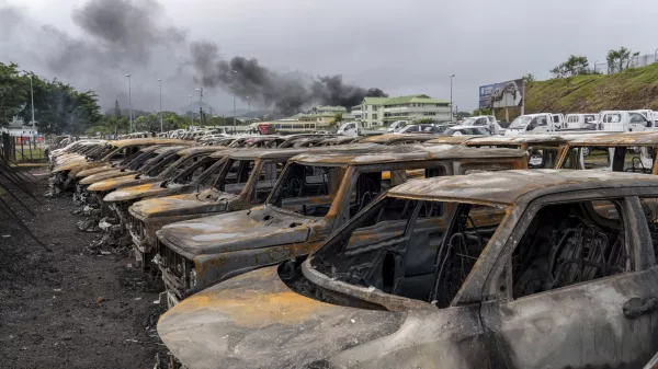 Burnt cars are lined up after unrest that erupted following protests over voting reforms in Noumea, New Caledonia, Wednesday, May 15, 2024. (AP Photo/Nicolas Job)