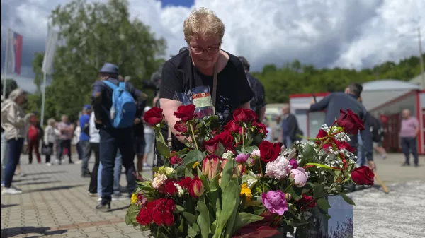 People arrive with flowers outside the F. D. Roosevelt University Hospital, where Slovak Prime Minister Robert Fico, who was shot and injured, is being treated, in Banska Bystrica, central Slovakia, Saturday, May 18, 2024. The man accused of attempting to assassinate Slovak Prime Minister Robert Fico made his first court appearance Saturday as the nation's leader remained in serious condition recovering from surgery after surviving multiple gunshots, Slovak state media said. (AP Photo/Lefteris Pitarakis)