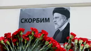 A view shows flowers outside the Iranian embassy placed to pay tribute to Iran's President Ebrahim Raisi, Foreign Minister Hossein Amirabdollahian and other victims of a recent helicopter crash in mountainous terrain near Iran's border with Azerbaijan, in Moscow, Russia, May 20, 2024. A placard with a portrait of Iran's President Ebrahim Raisi reads: "We mourn". REUTERS/Maxim Shemetov