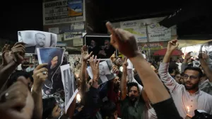 Shiite Muslims hold photos of Iranian President Ebrahim Raisi and others leaders shout slogans during a candlelight vigil in Srinagar, Indian controlled Kashmir, Monday, May 20, 2024. Raisi and several other officials were found dead on Monday, hours after their helicopter crashed in a foggy, mountainous region of Iran's northwest, state media reported. (AP Photo/Mukhtar Khan)