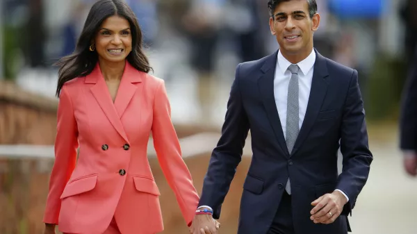 FILE - British Prime Minister Rishi Sunak and wife Akshata Murty arrive at the Conservative Party annual conference at Manchester Central convention complex in Manchester, England, Wednesday, Oct. 4, 2023. (AP Photo/Jon Super, File)