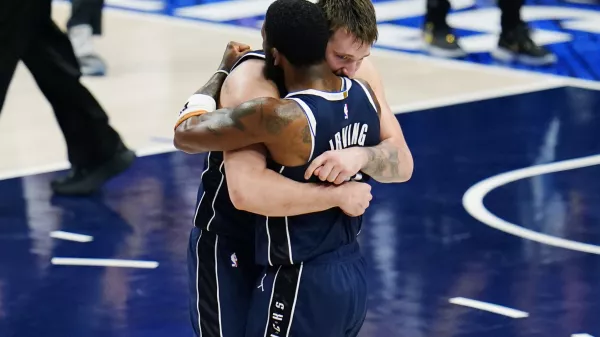 Dallas Mavericks guard Luka Doncic, left, and guard Kyrie Irving, right, embrace after their win over theMinnesota Timberwolves in Game 3 of the NBA basketball Western Conference finals, Sunday, May 26, 2024, in Dallas. (AP Photo/Gareth Patterson)