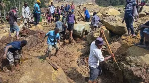 CORRECTS TO YAMBALI FOR LOCATION, NOT POGERA - Villagers search through a landslide in Yambali, in the Highlands of Papua New Guinea, Sunday, May 26, 2024. The International Organization for Migration feared Sunday the death toll from a massive landslide is much worse than what authorities initially estimated. (Mohamud Omer/International Organization for Migration via AP)