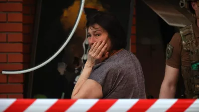 25 May 2024, Ukraine, Kharkiv: A woman cries near an office building that was destroyed by a Russian missile attack in the center of Kharkiv in northeastern Ukraine. Photo: -/Ukrinform/dpa