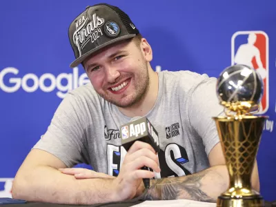 Dallas Mavericks guard Luka Doncic smiles during a news conference after the team's win over the Minnesota Timberwolves in Game 5 of the NBA basketball Western Conference finals Thursday, May 30, 2024, in Minneapolis. (AP Photo/Matt Krohn)