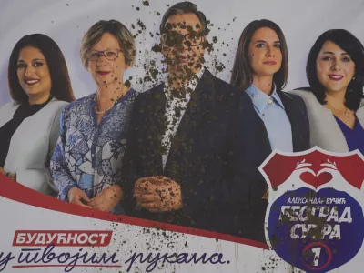 A vandalized pre-election billboard showing Serbian President Aleksandar Vucic, center, with associates, reading: "The future is in your hands" in Belgrade, Serbia, Thursday, May 30, 2024, ahead of the municipal vote set for June 2. Voters in Serbia go to the polls this weekend in a municipal election for dozens of cities and towns, including a rerun vote in the capital Belgrade where ruling populists were accused of a fraud at a previous vote in December. The right-wing Serbian Progressive Party of President Aleksandar Vucic is seen as a favorite ahead of the Sunday balloting which could further secure the strongman's already vast hold on power. (AP Photo/Darko Vojinovic)