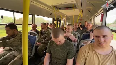 In this photo taken from video released by the Russian Defense Ministry Press Service on Friday, May 31, 2024, a group of Russian soldiers drive in a bus after being released in a prisoners swap between Russia and Ukraine, at an unspecified location. Russia released 75 Ukrainian prisoners of war and Ukraine turned over the same number on Friday as the fighting continued. (Russian Defense Ministry Press Service via AP)