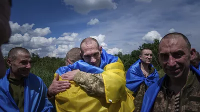 A Ukrainian serviceman hugs his comrade after returning from captivity during a POWs exchange in Sumy region, Ukraine, Friday, May 31, 2024. Ukraine returned 75 prisoners, including four civilians, in the latest exchange of POWs with Russia. It's the fourth prisoner swap this year, and 52nd since Russia invaded Ukraine. In all, 3 210 Ukrainian servicemen and civilians were returned since the outbreak of the war. (AP Photo/Evgeniy Maloletka)