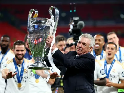 Soccer Football - Champions League - Final - Borussia Dortmund v Real Madrid - Wembley Stadium, London, Britain - June 1, 2024 Real Madrid coach Carlo Ancelotti celebrates with the trophy after winning the Champions League REUTERS/Hannah Mckay