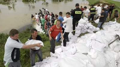 People use sand bags to reinforce broken embankments along Opatowka River in Dwikozy, near Sandomierz, southern Poland June 7, 2010.  Heavy rains triggered fresh floods in central Europe last week. Flooding around the region in May caused hundreds of million of dollars of damage and killed at least 18 people in Poland. REUTERS/Agencja Gazeta/Pawel Malecki (POLAND - Tags: ENVIRONMENT DISASTER) POLAND OUT. NO COMMERCIAL OR EDITORIAL SALES IN POLAND