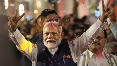 Prime Minister Narendra Modi greets supporters as he arrives at Bharatiya Janata Party (BJP) headquarters in New Delhi, India, Tuesday, June 4, 2024. (AP Photo/Manish Swarup)