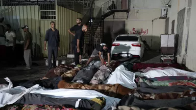 Palestinians check the bodies of their relatives killed in an Israeli bombardment of UNRWA school at Nusseirat refugee camp, in front of the morgue of al-Aqsa Martyrs hospital in Deir al-Balah, central Gaza Strip, early Thursday, June 6, 2024. (AP Photo/Abdel Kareem Hana)