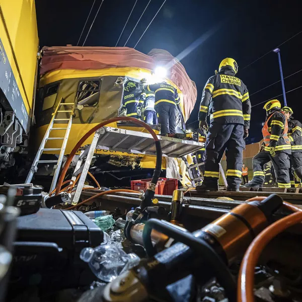 In this photo released by Fire Department of Pardubice region, rescue workers help injured passengers after two trains collided in Pardubice, Czech Republic Thursday, June 6, 2024. A passenger train collided head-on with a freight train in the Czech Republic, killing and injuring some people, officials said early Thursday. (Fire Department of Pardubice region via AP)