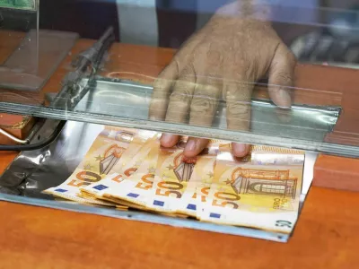 Cash money euro, at bank office or currency exchanger. Male hand with euro money in cash department window. Currency exchange concept. Clerk giving cash money to customer at bank office.