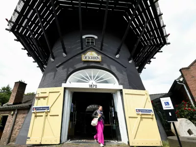 A woman walks out of a mill after voting in the European Union's parliamentary elections in Arnhem, Netherlands, June 6, 2024. REUTERS/Piroschka van de Wouw