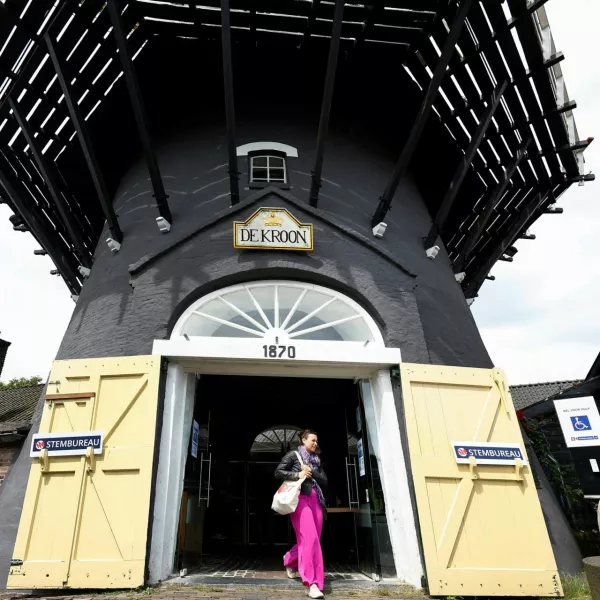 A woman walks out of a mill after voting in the European Union's parliamentary elections in Arnhem, Netherlands, June 6, 2024. REUTERS/Piroschka van de Wouw