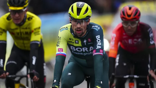 FILE - Slovenia's Primoz Roglic crosses the finish line during the sixth stage of the Paris-Nice cycling race in La Colle-sur-Loup, outside Nice, on March 8, 2024. Tour de France favorites Remco Evenepoel and Primoz Roglic were caught up in a massive crash Thursday June 6, 2024 at the Criterium du Dauphine race that led organizers to neutralize the stage. (AP Photo/Daniel Cole, File)