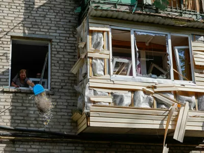 A woman cleans debris from an apartment in a multi-storey residential building damaged in recent shelling by U.S.-supplied ATACMS missiles, according the Russian Defence Ministry, in the course of Russia-Ukraine conflict in Luhansk, Russian-controlled Ukraine, June 7, 2024. REUTERS/Alexander Ermochenko   TPX IMAGES OF THE DAY