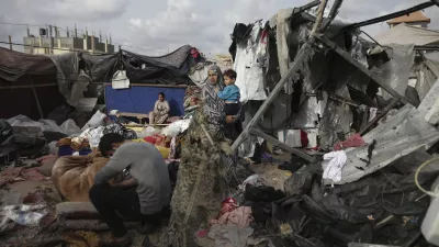 FILE - Displaced Palestinians inspect their tents destroyed by Israel's bombardment, adjunct to an UNRWA facility west of Rafah city, Gaza Strip, Tuesday, May 28, 2024. A single image, not even an authentic photograph, is the focus of a singular campaign on Instagram that has caught the attention of the algorithm and captured the imaginations of users across national borders — a show of support for the Palestinian movement as the war between Israel and Hamas enters its eighth month. (AP Photo/Jehad Alshrafi, File)