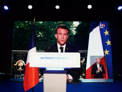 French President Emmanuel Macron speaks through a screen at the far-right National Rally (Rassemblement National - RN) party headquarters after the polls closed during the European Parliament elections, in Paris, France, June 9, 2024. REUTERS/Sarah Meyssonnier