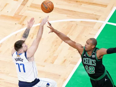 Jun 9, 2024; Boston, Massachusetts, USA; Dallas Mavericks guard Luka Doncic (77) shoots against Boston Celtics center Al Horford (42) in the first quarter during game two of the 2024 NBA Finals at TD Garden. Mandatory Credit: David Butler II-USA TODAY Sports