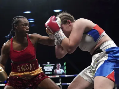 Boxers Claressa Shields, left, and Ema Kozin battle for the WBC/WBA/IBF World Middleweight titles, Saturday, Feb. 5, 2022 at the Motorpoint Arena in Cardiff, Wales. (Nick Potts(/PA via AP)