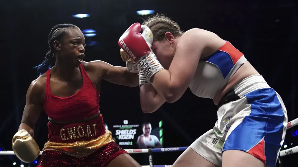 Boxers Claressa Shields, left, and Ema Kozin battle for the WBC/WBA/IBF World Middleweight titles, Saturday, Feb. 5, 2022 at the Motorpoint Arena in Cardiff, Wales. (Nick Potts(/PA via AP)