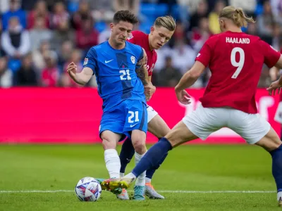 Slovenia's Tomi Horvat, centre, vies for the ball with Norway's Marcus Holmgren Pedersen, background and Erling Braut Haaland, during the Nations League soccer match between Norway and Slovenia at Ullevaal Stadium, in Oslo, Norway, Thursday, June 9, 2022. (Javad Parsa/NTB Scanpix via AP)