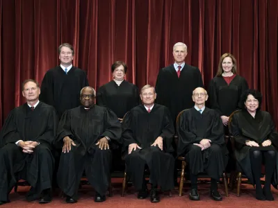 FILE - Members of the Supreme Court pose for a group photo at the Supreme Court in Washington, April 23, 2021. Seated from left are Associate Justice Samuel Alito, Associate Justice Clarence Thomas, Chief Justice John Roberts, Associate Justice Stephen Breyer and Associate Justice Sonia Sotomayor, Standing from left are Associate Justice Brett Kavanaugh, Associate Justice Elena Kagan, Associate Justice Neil Gorsuch and Associate Justice Amy Coney Barrett. In one form or another, every Supreme Court nominee is asked during Senate hearings about his or her views of the landmark abortion rights ruling that has stood for a half century. Now, a draft opinion obtained by Politico suggests that a majority of the court is prepared to strike down the Roe v. Wade decision from 1973, leaving it to the states to determine a woman's ability to get an abortion. (Erin Schaff/The New York Times via AP, Pool, File)