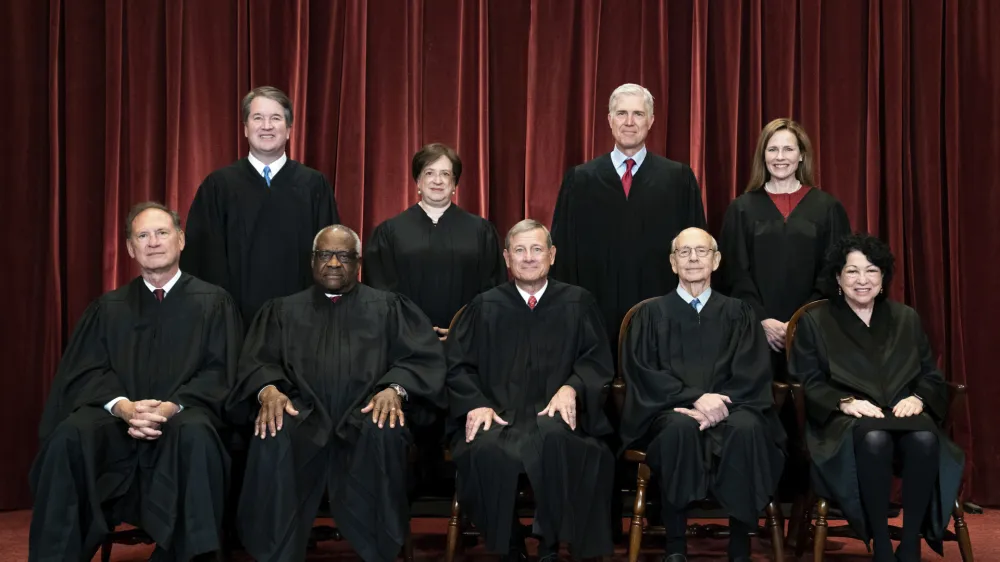 FILE - Members of the Supreme Court pose for a group photo at the Supreme Court in Washington, April 23, 2021. Seated from left are Associate Justice Samuel Alito, Associate Justice Clarence Thomas, Chief Justice John Roberts, Associate Justice Stephen Breyer and Associate Justice Sonia Sotomayor, Standing from left are Associate Justice Brett Kavanaugh, Associate Justice Elena Kagan, Associate Justice Neil Gorsuch and Associate Justice Amy Coney Barrett. In one form or another, every Supreme Court nominee is asked during Senate hearings about his or her views of the landmark abortion rights ruling that has stood for a half century. Now, a draft opinion obtained by Politico suggests that a majority of the court is prepared to strike down the Roe v. Wade decision from 1973, leaving it to the states to determine a woman's ability to get an abortion. (Erin Schaff/The New York Times via AP, Pool, File)