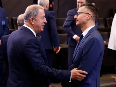 Turkish Defence Minister Hulusi Akar talks with Slovenia's Defence Minister Marjan Sarec as they take part in a NATO defence ministers meeting at the Alliance's headquarters in Brussels, Belgium June 16, 2022. REUTERS/Yves Herman