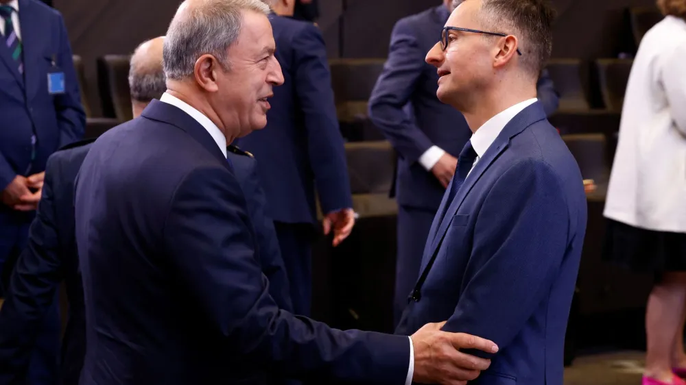 Turkish Defence Minister Hulusi Akar talks with Slovenia's Defence Minister Marjan Sarec as they take part in a NATO defence ministers meeting at the Alliance's headquarters in Brussels, Belgium June 16, 2022. REUTERS/Yves Herman