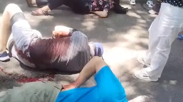 People gather around four American educators from an Iowa university, who were reportedly stabbed in a public park, according to the U.S. media and U.S. government officials, in Jilin City, Jilin province, China, in this still image taken from a video obtained by Reuters and released on June 10, 2024. Video obtained by REUTERS THIS IMAGE HAS BEEN SUPPLIED BY A THIRD PARTY. NO RESALES. NO ARCHIVES.