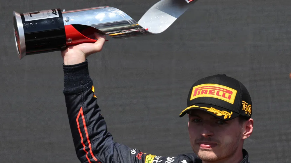 Formula One F1 - Canadian Grand Prix - Circuit Gilles Villeneuve, Montreal, Canada - June 19, 2022 Red Bull's Max Verstappen celebrates with a trophy on the podium after winning the race REUTERS/Chris Helgren