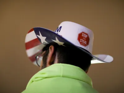 FILE PHOTO: A supporter of U.S. President Donald Trump wearing a hat with a sticker on it reading "Stop the Steal" attends a rally ahead of the U.S. Congress certification of the November 2020 election results, during protests in Washington, U.S., January 5, 2021. REUTERS/Leah Millis/File Photo