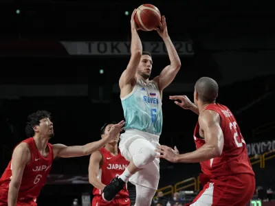 Slovenia's Aleksej Nikolic (6) drives to the basket over Japan's Gavin Earl Edwards (23), right, during men's basketball preliminary round game at the 2020 Summer Olympics, Thursday, July 29, 2021, in Saitama, Japan. (AP Photo/Eric Gay)