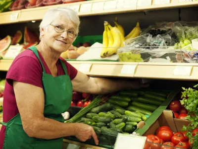 Senior woman arranging vegetables on shelf