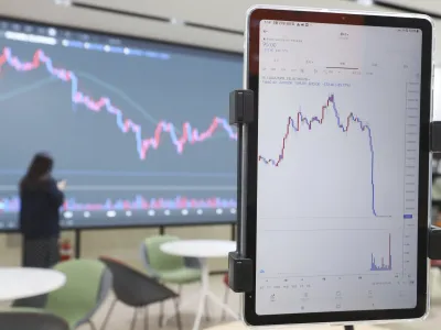 A screen, right, showing the falling values of the Luna is seen at a cryptocurrency exchange in Seoul, South Korea, Friday, May 27 2022. South Korean prosecutors have announced Wednesday, June 22, 2022, that they have barred dozens of people connected to Terraform Labs from leaving the country as they expand an investigation into a  billion collapse of the company's cryptocurrency that devastated traders around the world. (Ryu Hyo-lim/Yonhap via AP)