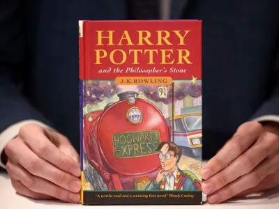 A person holds a rare first edition and signed by the author copy of 'Harry Potter and the Philosophers Stone' by British author J.K. Rowling, which is to be put up for sale at Christie's auction house in London, Britain May 31, 2022. REUTERS/Henry Nicholls