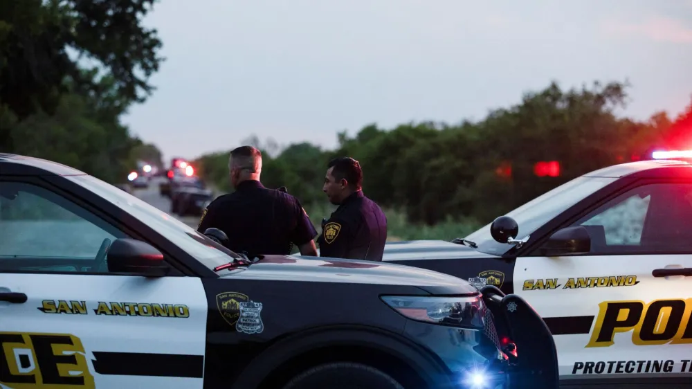 Law enforcement officers work at the scene where people were found dead inside a trailer truck in San Antonio, Texas, U.S. June 27, 2022. REUTERS/Kaylee Greenlee Beal