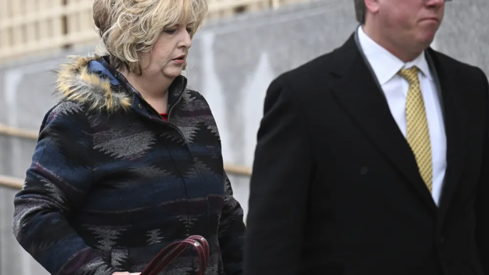 Megan Hess, left, arrives to the Wayne Aspinall Courthouse with her attorney for her and her mother's Shirley Koch sentencing trial on Tuesday, Jan. 3, 2023 in Grand Junction, Colo. Hess, a funeral home operator accused of illegally selling body parts and giving clients fake ashes was sentenced to 20 years in prison Tuesday by a federal court judge. U.S. authorities say that on dozens of occasions Hess and her mother, Shirley Koch, transferred bodies or body parts to third parties for research without families' knowledge.  (RJ Sangosti/The Denver Post via AP)