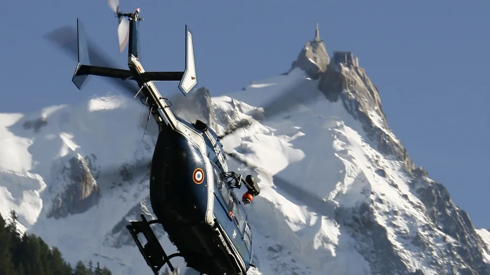 REFILE- CORRECTING YEAR<br><br>A French Gendarmerie rescue helicopter passes in front of the Aiguille du Midi as it takes off near Chamonix during search and rescue operations August 24, 2008. An avalanche hit climbers on Mont Blanc early August 24, injuring eight and leaving about ten others missing, according to the local rescue officials. REUTERS/Christian Hartmann (FRANCE)